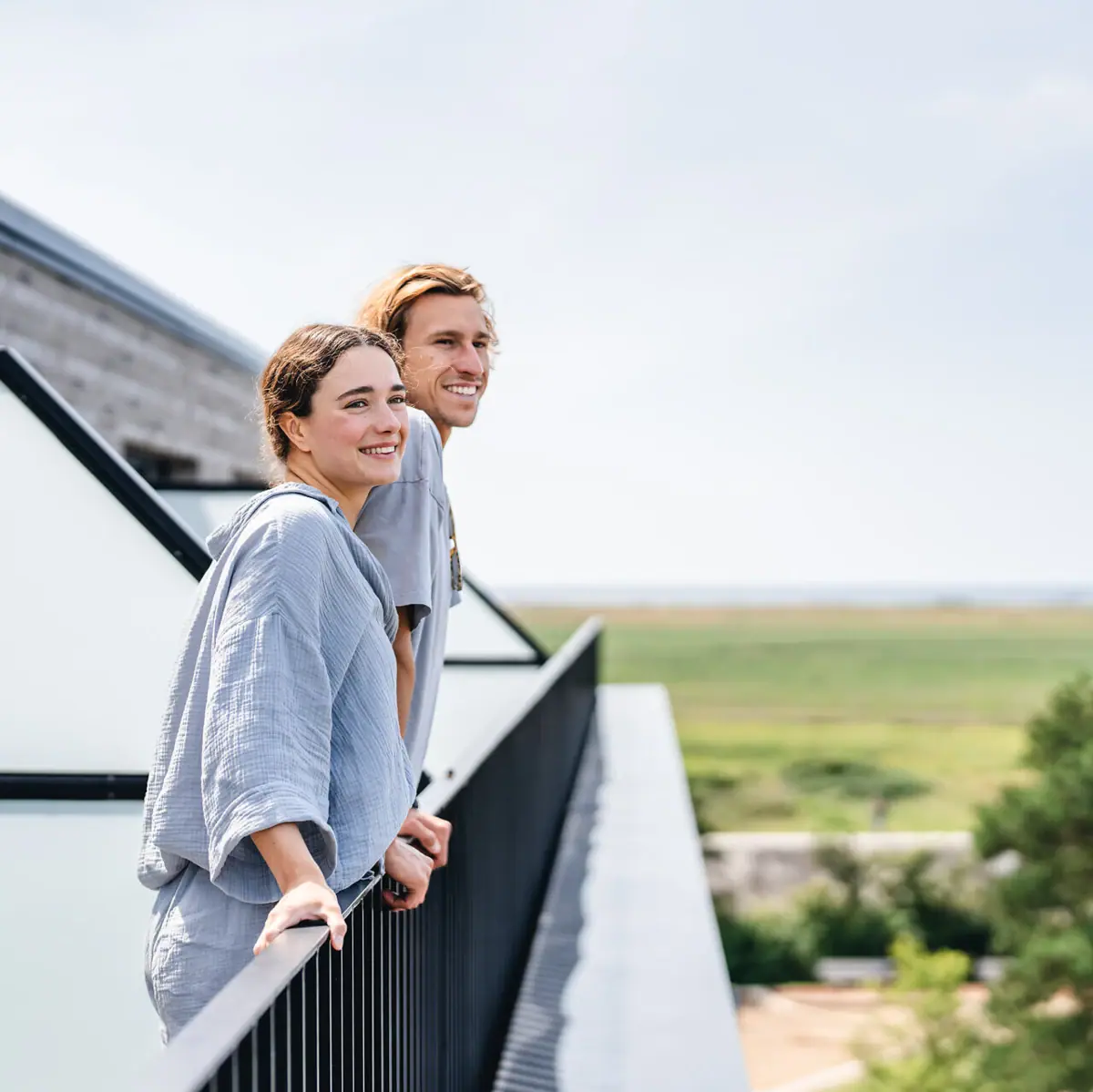 Urban Nature St Peter Ording A man and a woman are standing on a balcony.