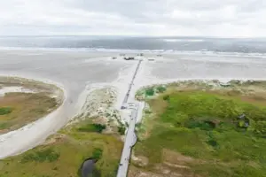 A path leads to a beach.