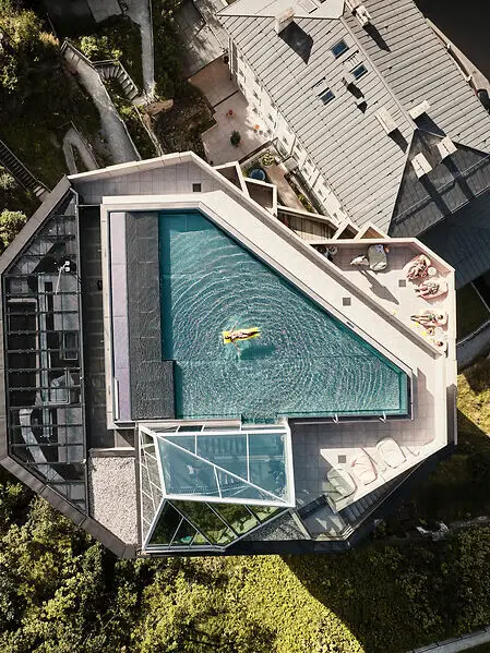 Infinity pool on the hotel roof with a view of Bad Gastein - aerial view of a modern wellness hotel in the Alps