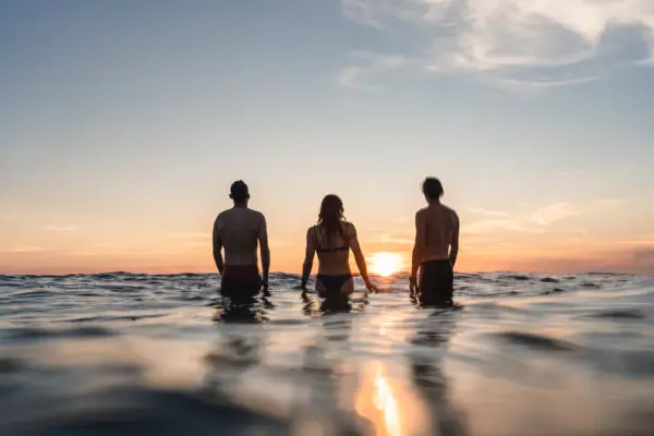 Summer in St Peter Ording A group of people are standing in the water.