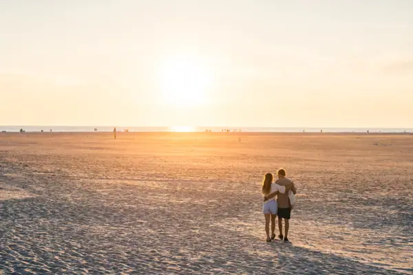 Ording North beach section Two people on the Ording Nord stretch of beach in St. Peter-Ording at sunset.