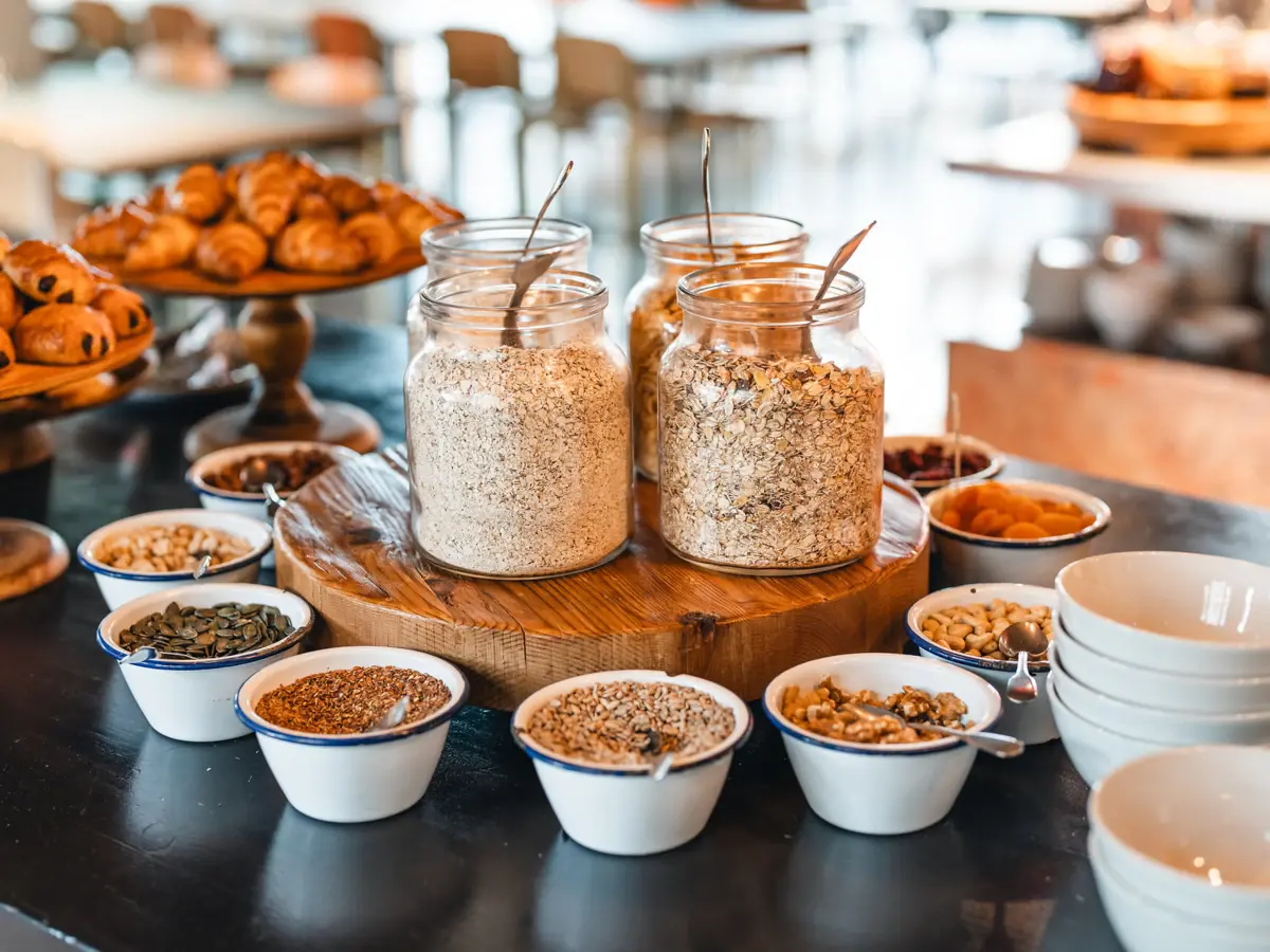 Muesli breakfast buffet St. Peter-Ording On a buffet table there are several glass containers with muesli and in front of them are many small bowls with nuts and toppings.