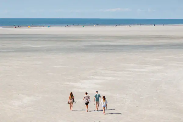 Böhl beach section A group of people walking along the beach.