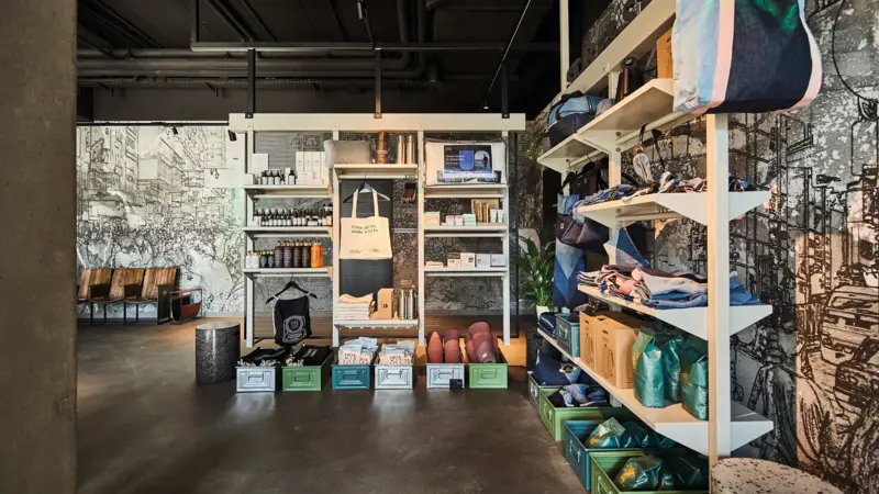 A retail space in the Urban Nature Hotel with shelves and lots of products.