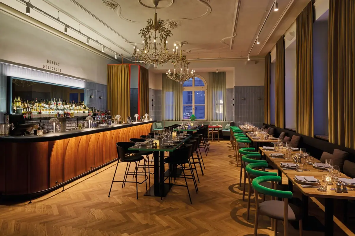 Stylish restaurant with elegant bar, chandeliers, long tables and modern design.