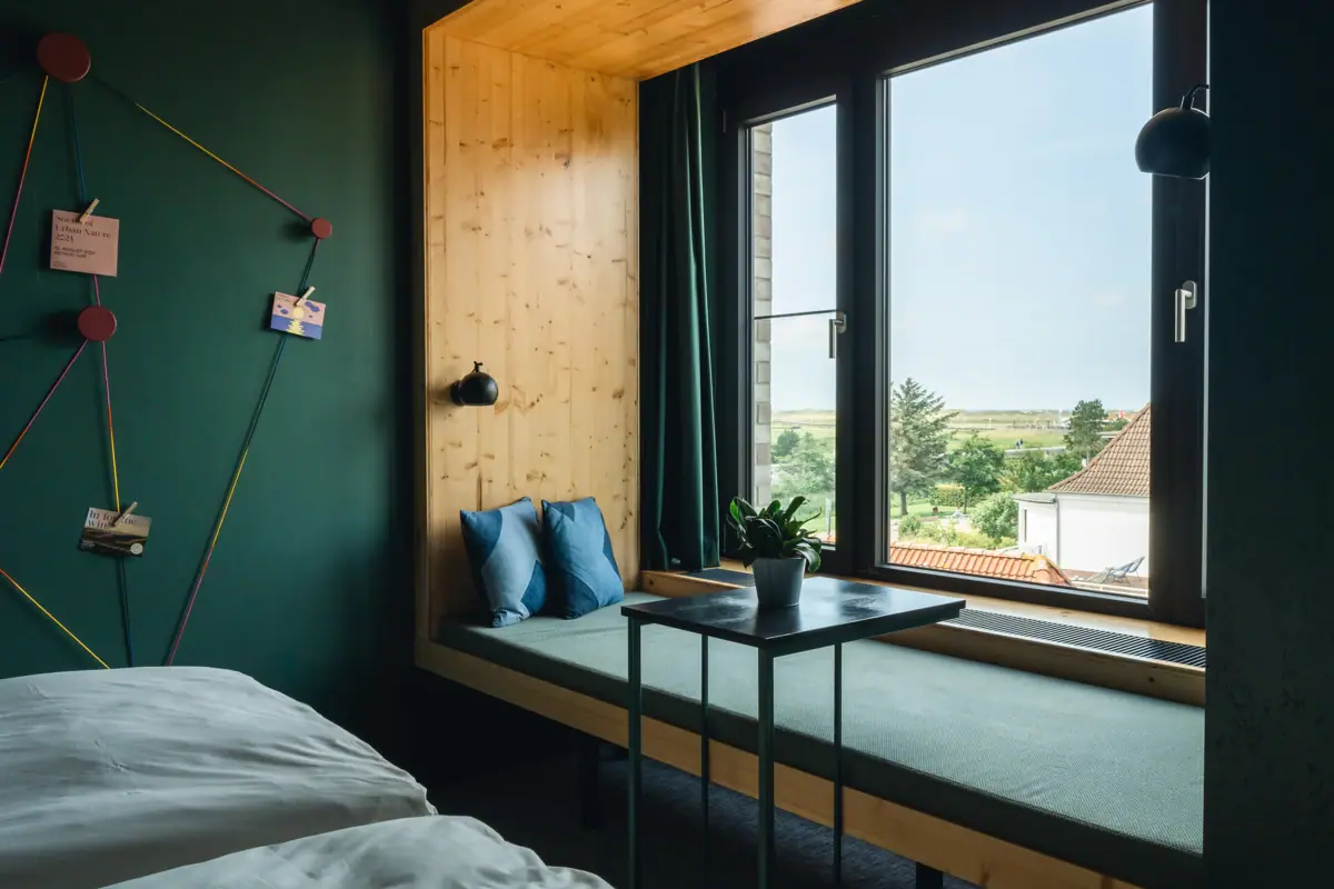 Accommodation in St. Peter-Ording A window with a day-bed and a view of the salt marshes at St Peter-Ording.