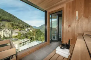 A room with a large window and a view of the mountains.
