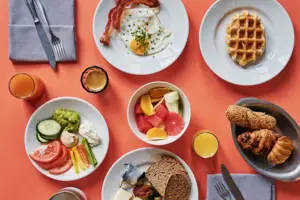A table with plates full of food and drinks.