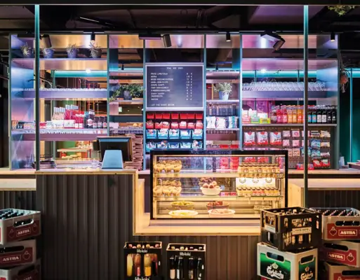 A kiosk with a counter and many beer crates in front of it.