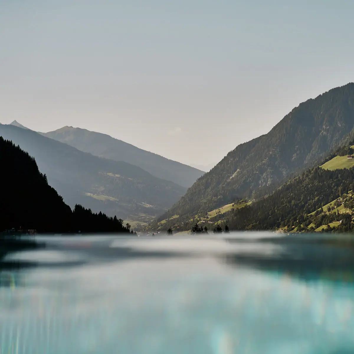Urban Nature Bad Gastein A body of water with mountains in the background.