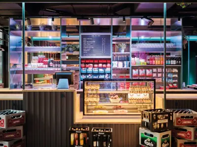 A kiosk with a counter and many beer crates in front of it.