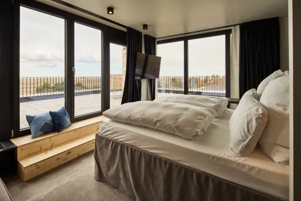 Urban Nature SPO Bedroom with a window and a television.