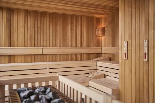 Sauna with a wooden lattice and a hot charcoal stove