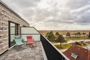 A terrace with chairs.
