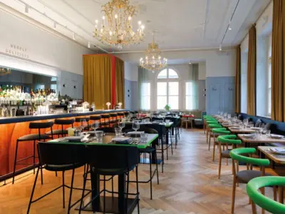 Stylish restaurant with elegant bar, chandeliers, long tables and modern design