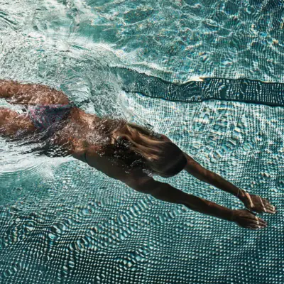 Bad Gastein Swimming Pool A woman is swimming in a pool.