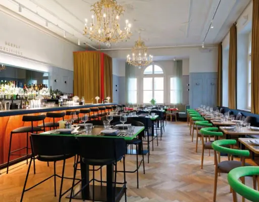 Stylish restaurant with elegant bar, chandeliers, long tables and modern design