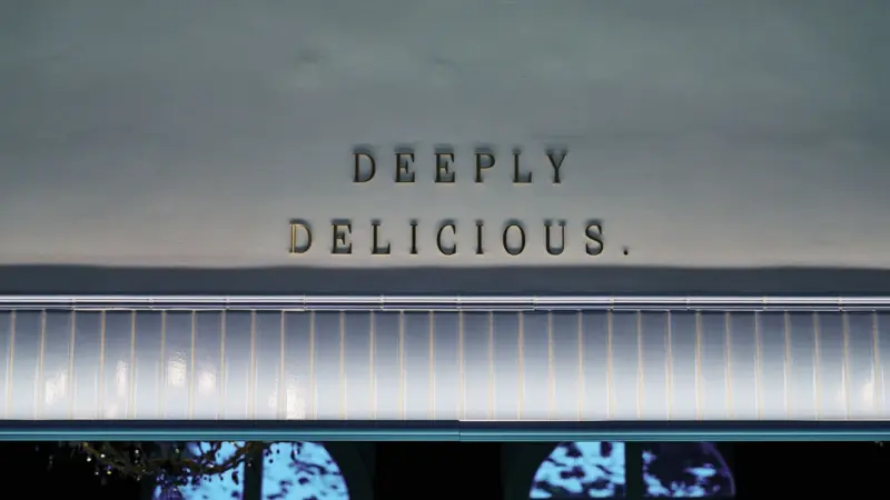Deeply Delicious The letters Deeply Delisious hang on one wall.