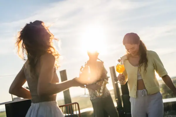 A group of people outdoors with drinks.