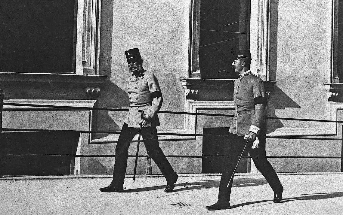An old black and white photo of two men in formal dress and hats.