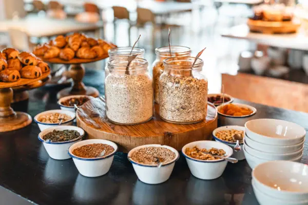 A group of glasses containing muesli and other food on a table.